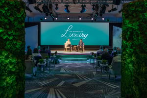 Two speakers sitting on stage discussing the business of luxury